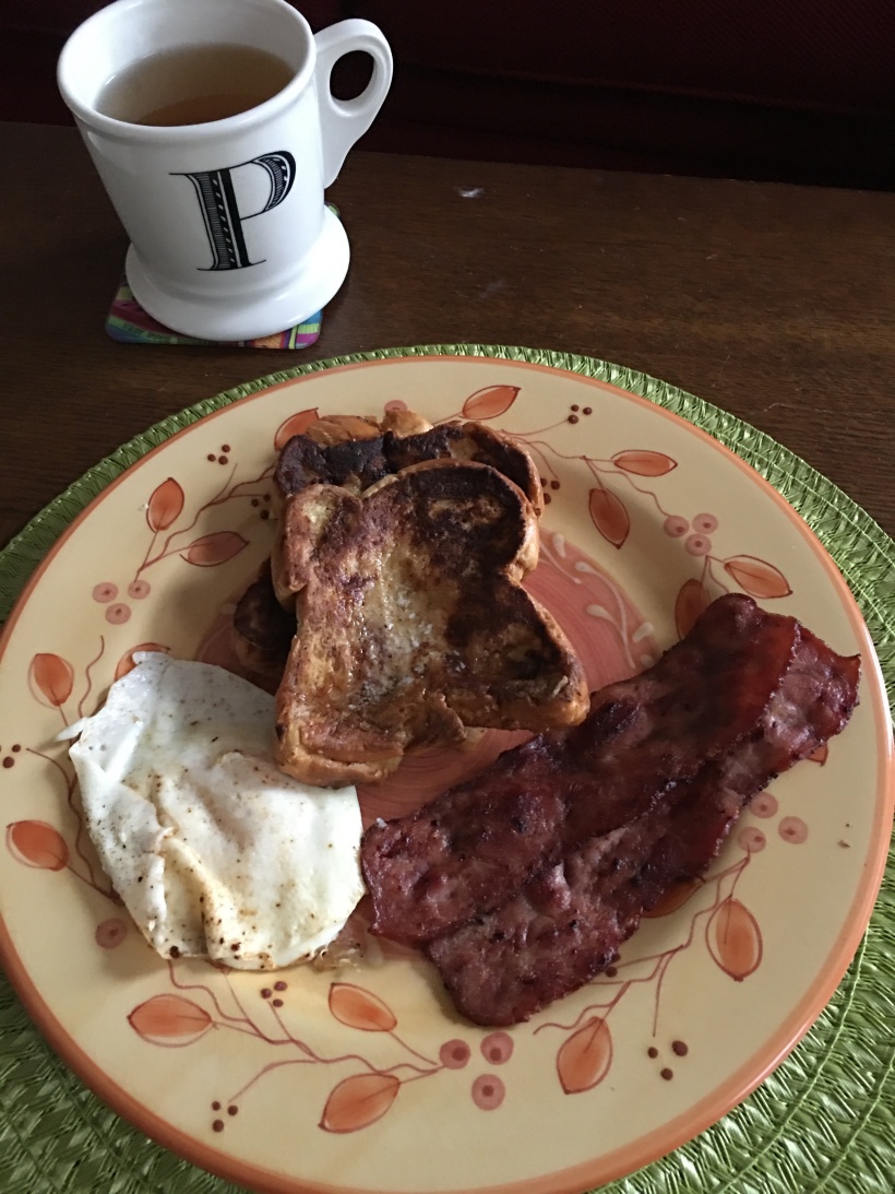 French toast, fried egg, turkey bacon, and tea